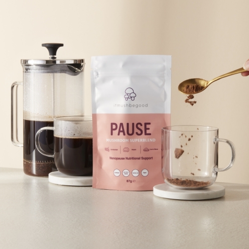 A serving of itmushbegood's PAUSE superblend being added to a cup of coffee